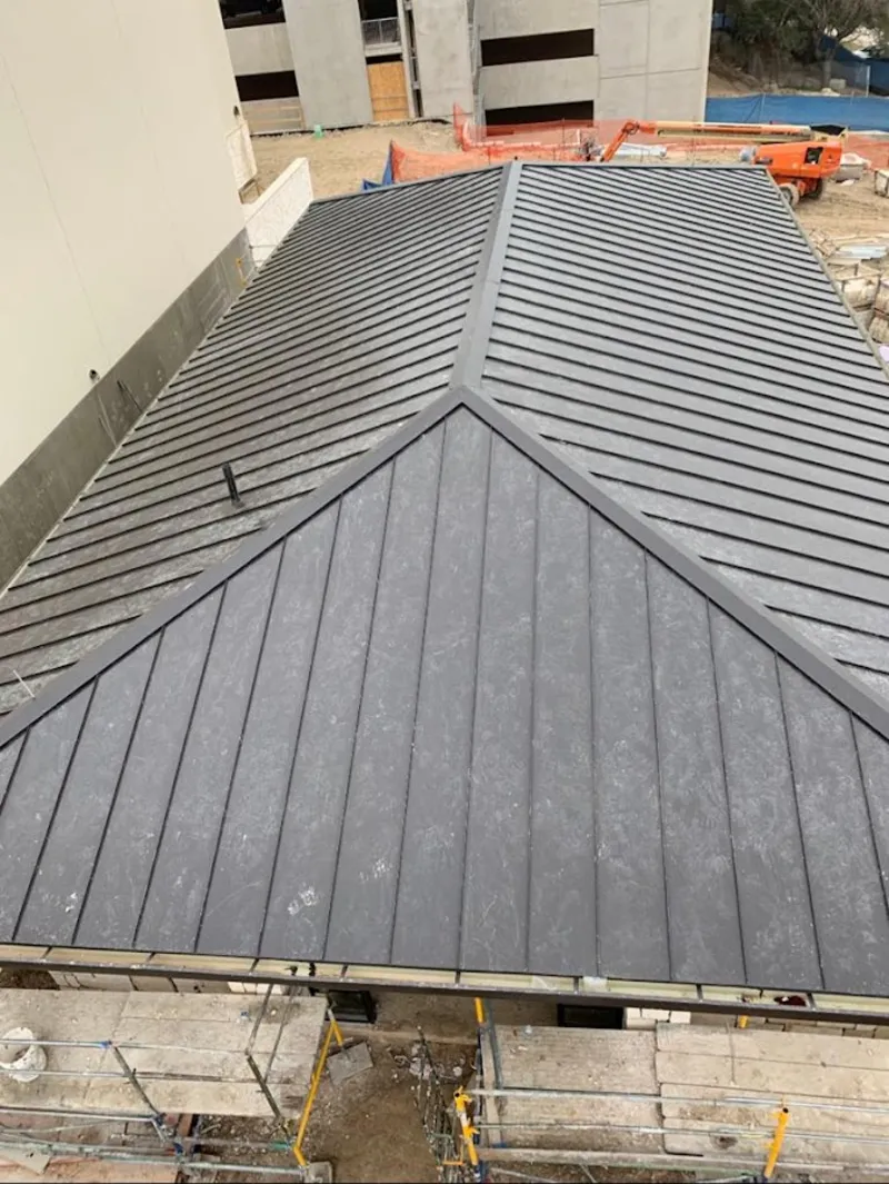 Commercial metal roof construction with crane equipment in Mundelein