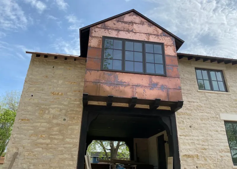 Copper metal panel facade on a stone building for Skylight Installation in Mundelein